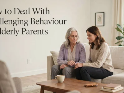 Adult daughter comforting her elderly mother on a couch while discussing challenging behavior in elderly parents